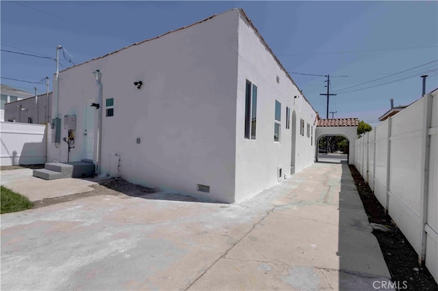 view of side of home featuring a patio