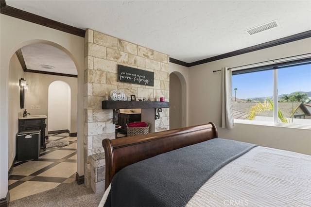 bedroom featuring a textured ceiling and crown molding