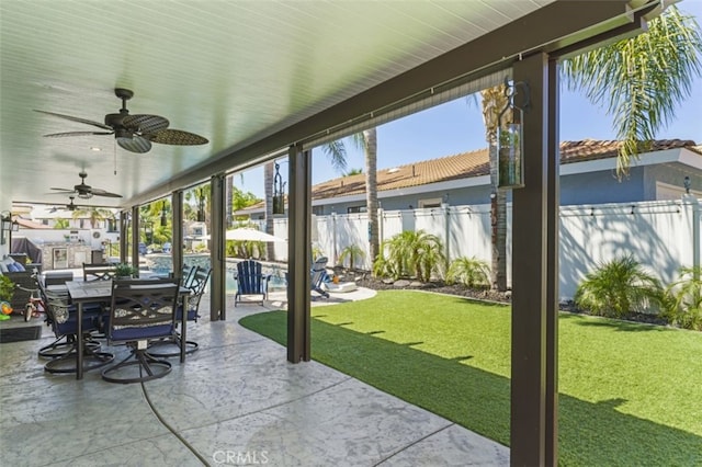 sunroom / solarium featuring ceiling fan