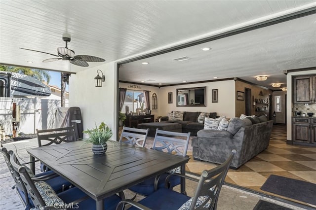 dining area featuring ceiling fan and ornamental molding