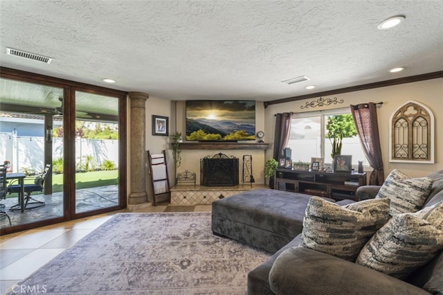 tiled living room featuring a textured ceiling and a fireplace