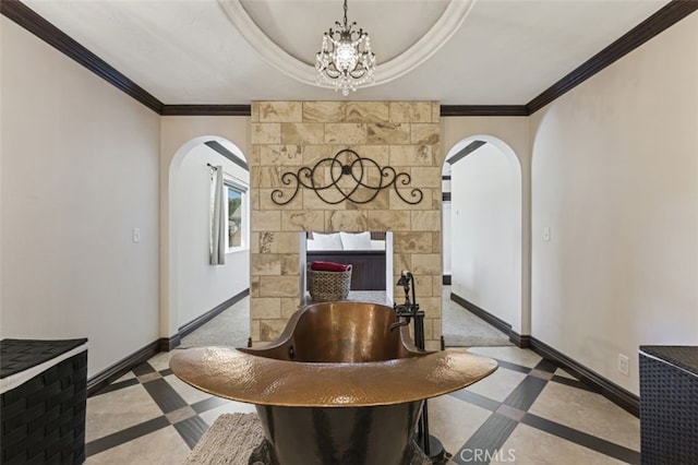 dining space with an inviting chandelier, ornamental molding, and a tray ceiling