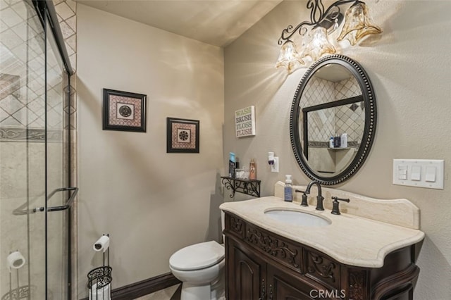 bathroom featuring toilet, vanity, and walk in shower