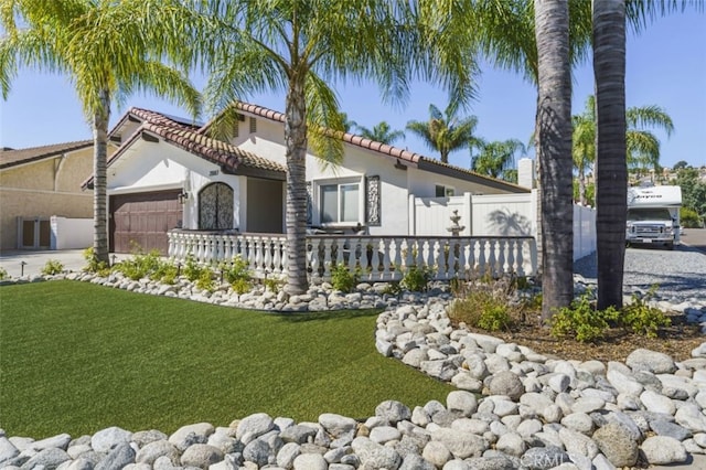 view of front of home featuring a garage and a front lawn