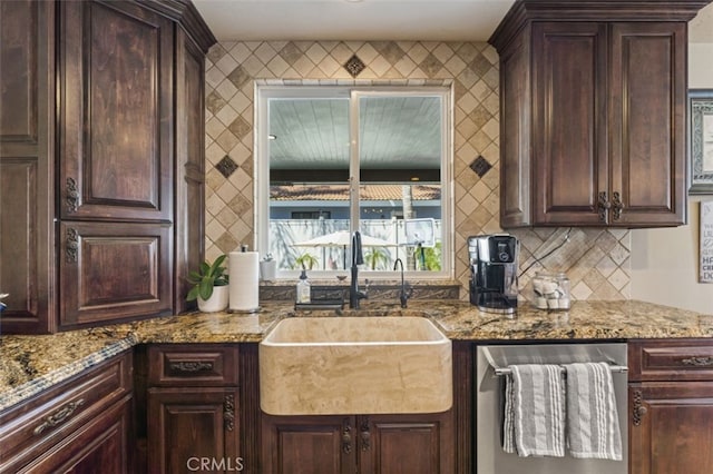 kitchen with dishwasher, sink, stone countertops, and dark brown cabinets