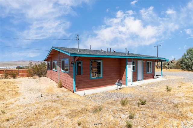 rear view of house with fence