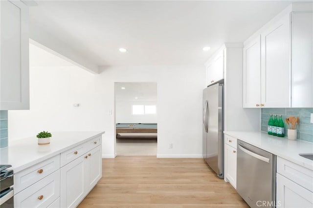 kitchen featuring white cabinetry, stainless steel appliances, and light wood-type flooring