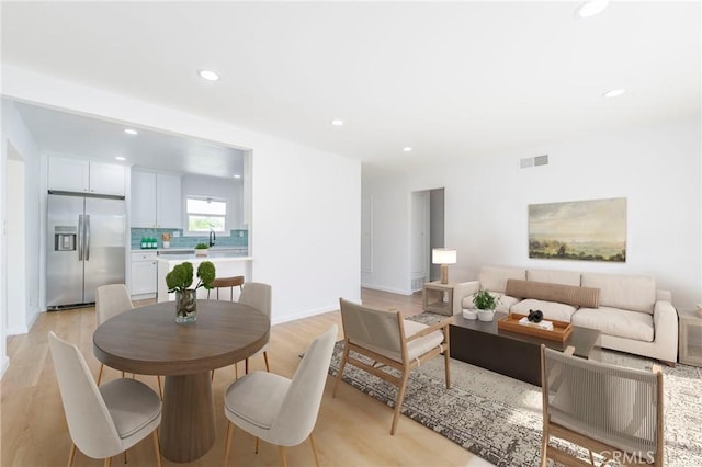 living room featuring light hardwood / wood-style floors and sink