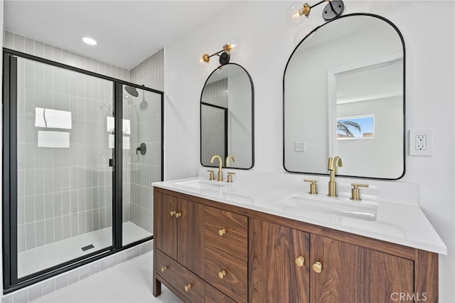 bathroom featuring tile patterned floors, vanity, and a shower with shower door