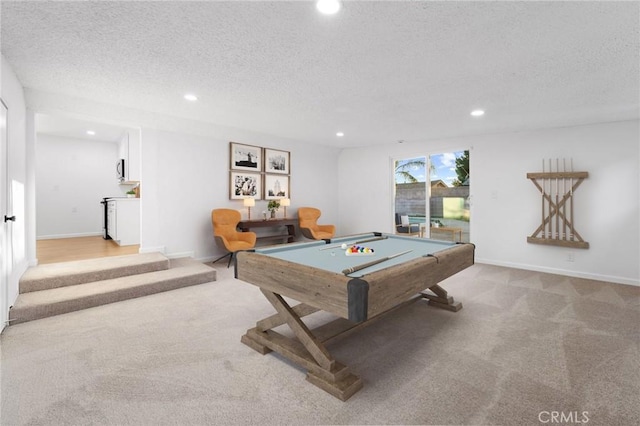 recreation room featuring a textured ceiling, light colored carpet, and pool table