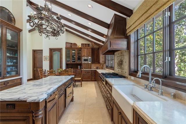 kitchen with tasteful backsplash, stainless steel microwave, premium range hood, beamed ceiling, and a sink