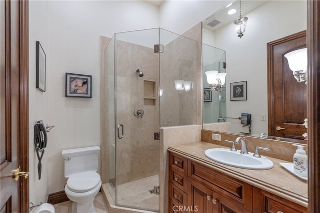 bathroom featuring vanity, toilet, visible vents, and a stall shower