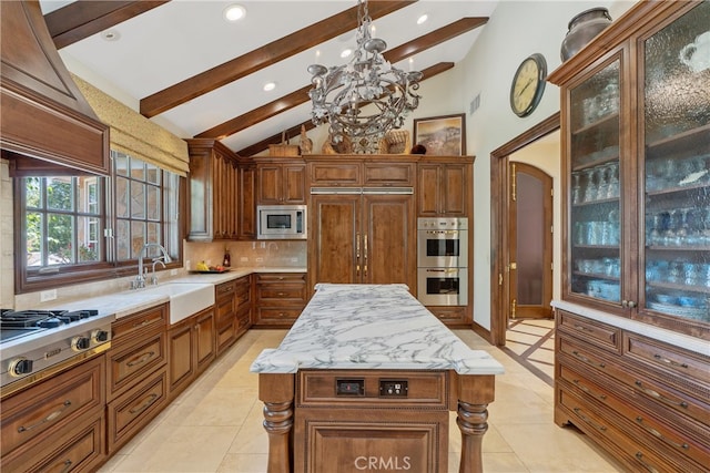 kitchen featuring a sink, built in appliances, beamed ceiling, a notable chandelier, and backsplash