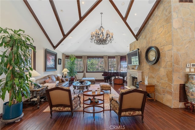 living area with visible vents, hardwood / wood-style floors, a fireplace, an inviting chandelier, and high vaulted ceiling