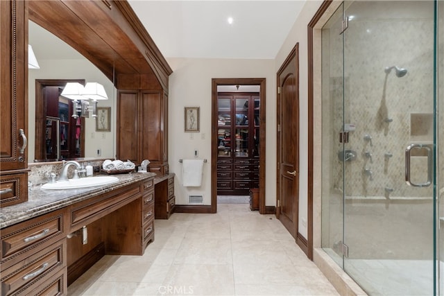 bathroom with visible vents, tile patterned floors, a stall shower, a closet, and vanity