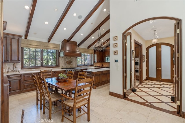 dining room with recessed lighting, arched walkways, an inviting chandelier, baseboards, and vaulted ceiling with beams