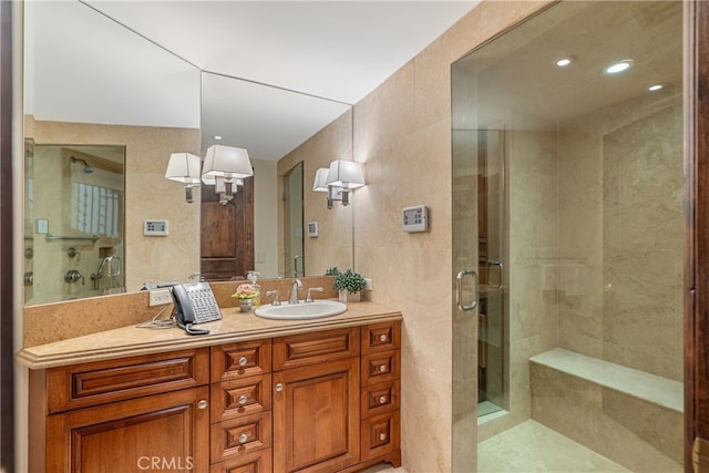 bathroom featuring a shower stall and vanity