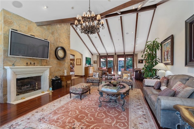 living area with wood finished floors, high vaulted ceiling, arched walkways, beamed ceiling, and a notable chandelier