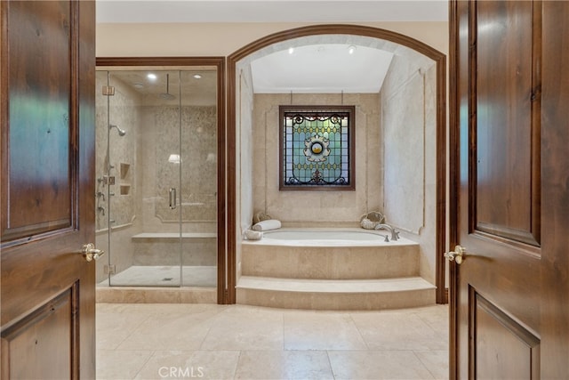 bathroom featuring tile patterned floors, a garden tub, and a shower stall