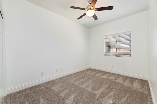 empty room featuring carpet floors and ceiling fan