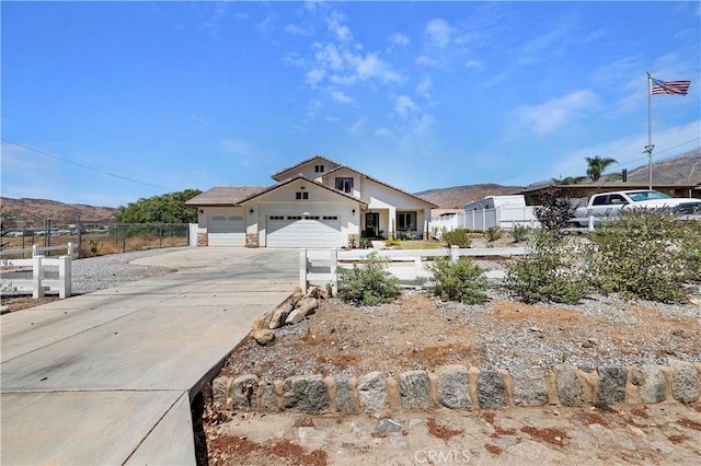 view of front of home with a mountain view and a garage