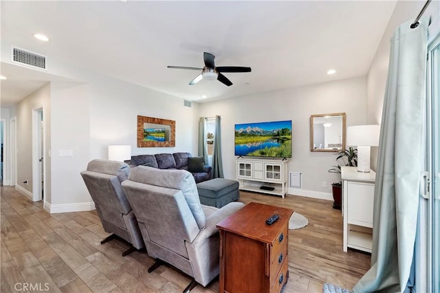 living room with ceiling fan and light hardwood / wood-style floors