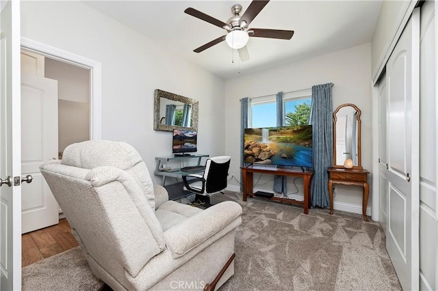 living area with light hardwood / wood-style floors and ceiling fan