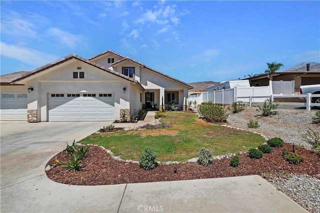 view of front of property with a front yard and a garage