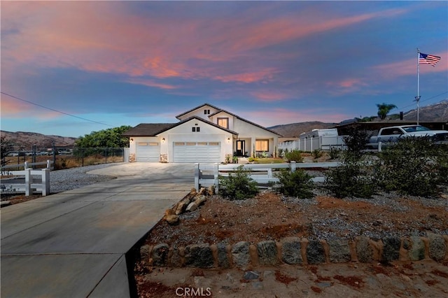 view of front of home with a mountain view and a garage