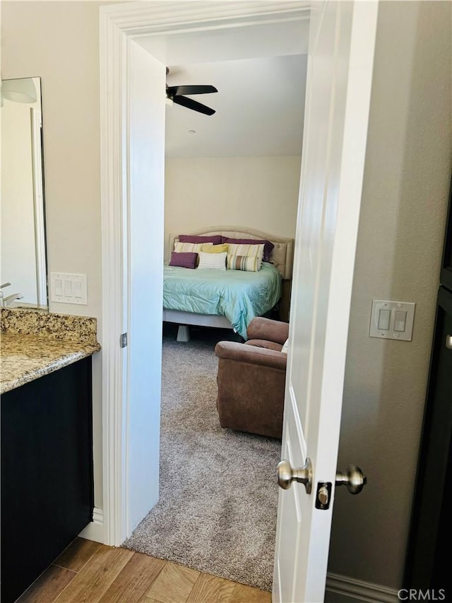 bedroom with light hardwood / wood-style floors and ceiling fan