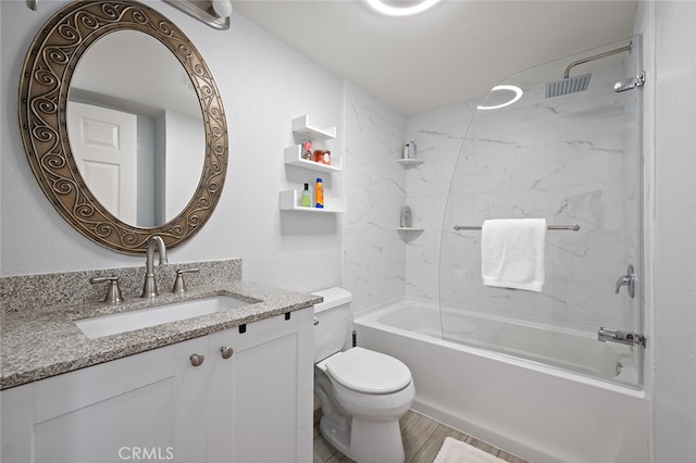 full bathroom with hardwood / wood-style flooring, vanity, toilet, and tiled shower / bath