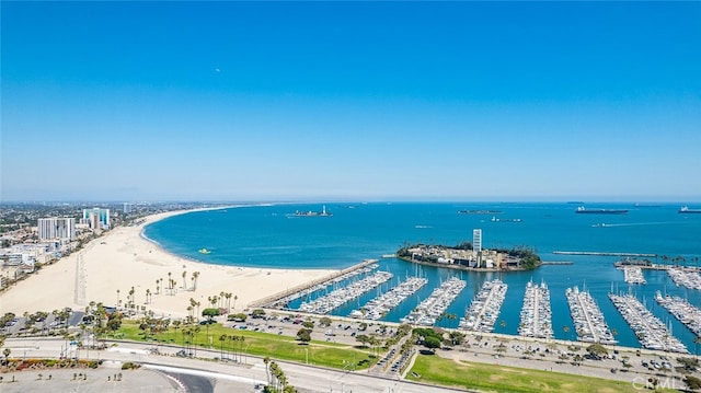 bird's eye view with a water view and a beach view