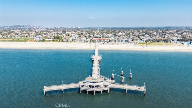 aerial view with a water view and a beach view