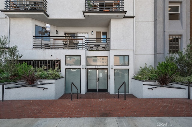 entrance to property featuring french doors and a balcony