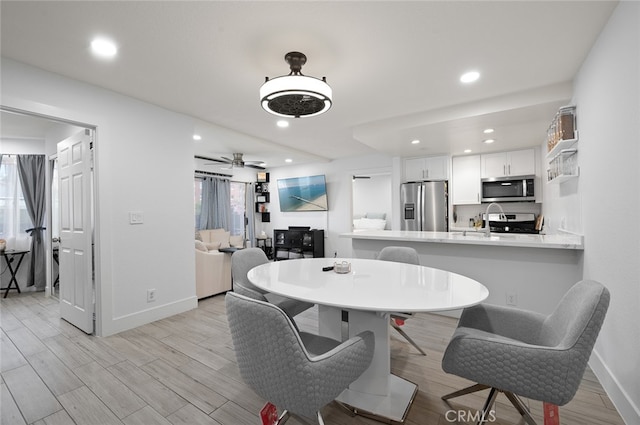 dining room featuring light hardwood / wood-style floors and ceiling fan