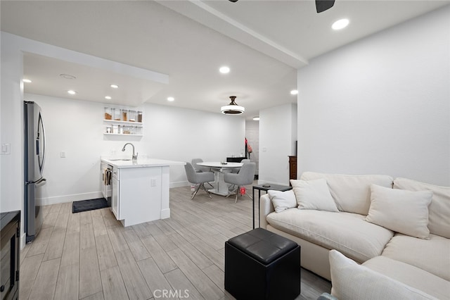 living room with indoor wet bar and light hardwood / wood-style floors