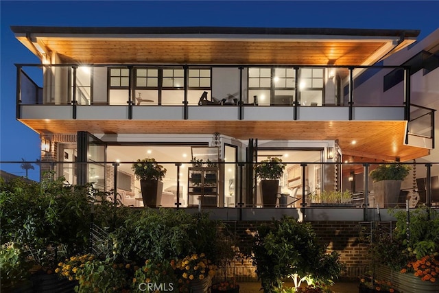 back house at night with a balcony