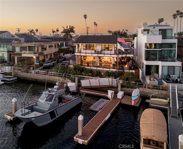 dock area featuring a residential view and a water view