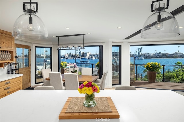 dining area featuring a water view and recessed lighting