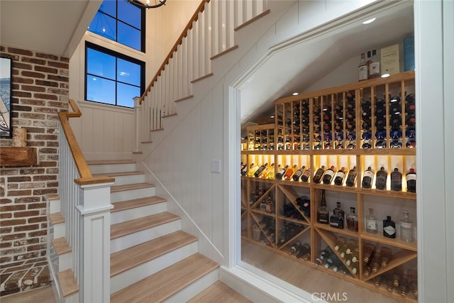 wine cellar with brick wall and wood finished floors