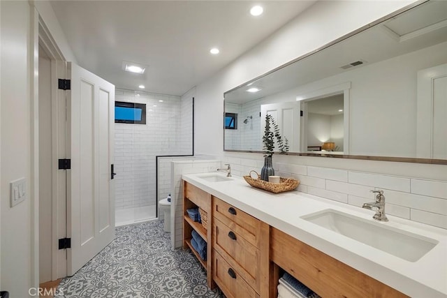 full bath with a stall shower, visible vents, and a sink