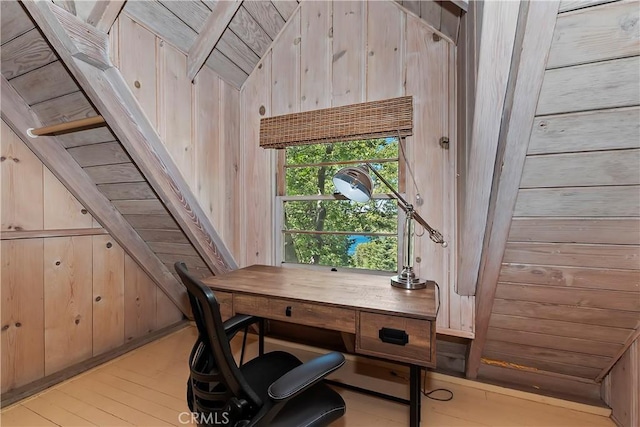 office featuring light hardwood / wood-style floors, vaulted ceiling, wooden walls, and wood ceiling