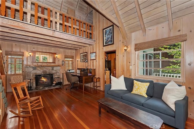 living room with wooden ceiling, high vaulted ceiling, hardwood / wood-style floors, wooden walls, and a fireplace