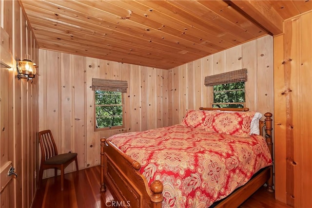 bedroom featuring wooden walls, dark hardwood / wood-style flooring, and wooden ceiling