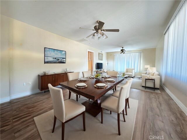 dining space with hardwood / wood-style floors and ceiling fan