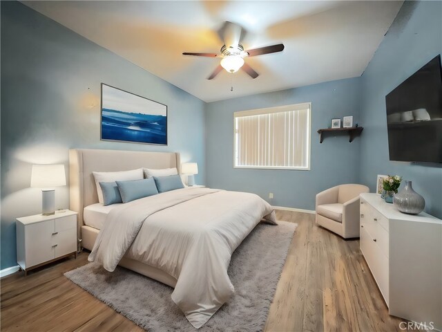 bedroom with ceiling fan and light wood-type flooring