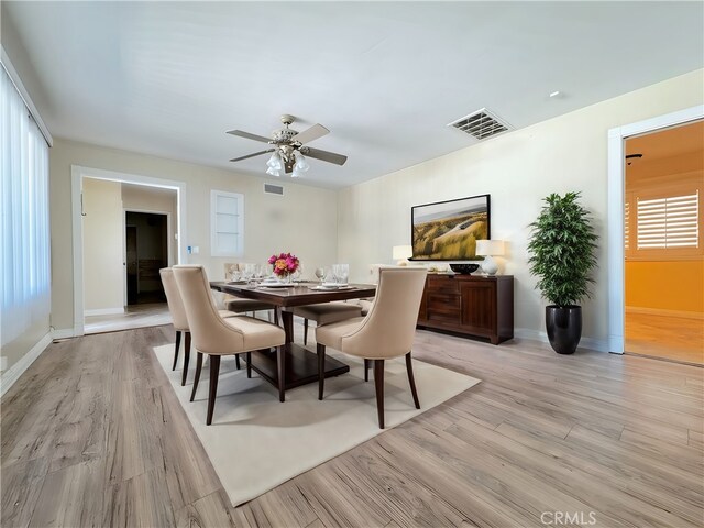 dining space with light hardwood / wood-style floors and ceiling fan