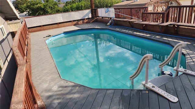 view of pool featuring a wooden deck