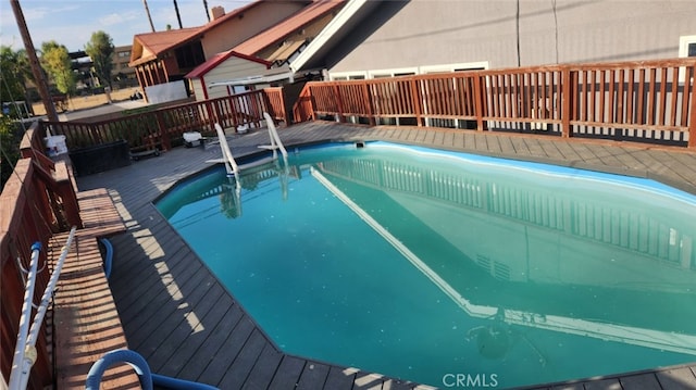 view of swimming pool with a wooden deck