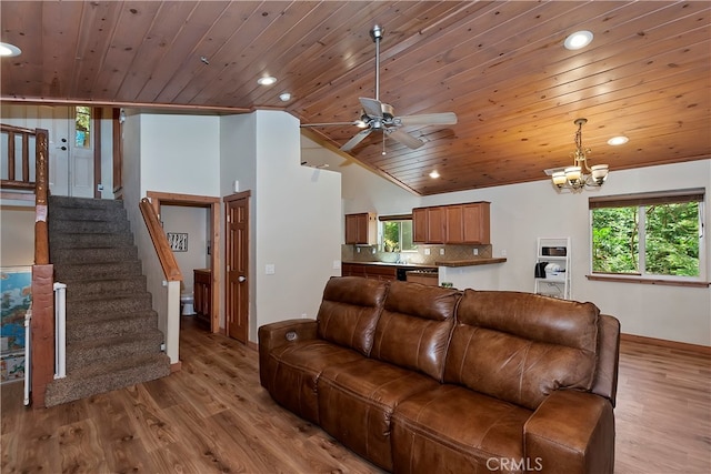 living room featuring wood ceiling, high vaulted ceiling, light hardwood / wood-style floors, and ceiling fan with notable chandelier